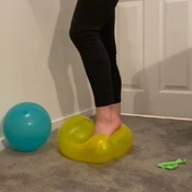 Lucy slowly bursting balloons