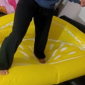 Barefeet walk and jump on yellow sofa and blue whale riding