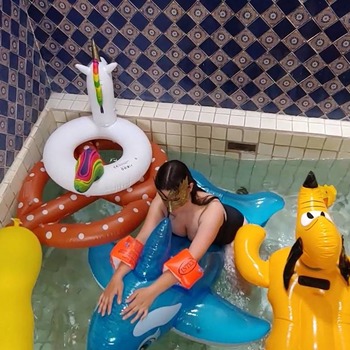 Gin ride blue whale and blow inflatable Pluto in the pool :)
