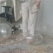 Kat bursting big clear balloons