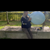 Blow to pop blue balloon outdoor