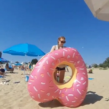Darina deflating donutheart float on the beach