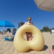 Darina deflating donutheart float on the beach