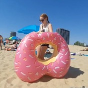 Darina deflating donutheart float on the beach