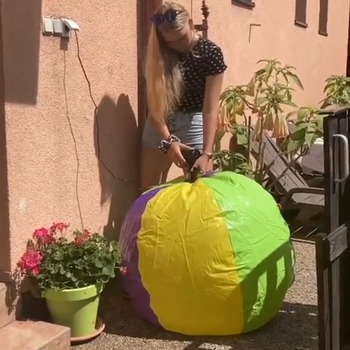 Jenny inflating big beach ball