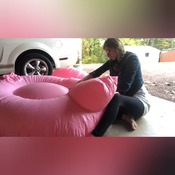 Mermaid inflating flamingo and other float