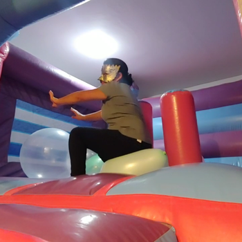 Popping balloons in the big inflatable castle!!