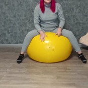 Valeria inflating and deflating green and yellow gymball