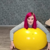 Valeria inflating and deflating green and yellow gymball