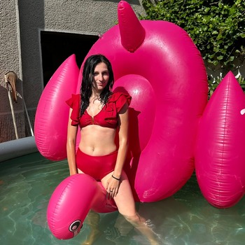 Lera with inflatable flamingo and donut and mattress