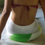 Girl destroy beach ball with the butt