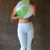Girl destroy beach ball with the butt