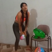 Girl sit to pop 2 beach balls and inflatable frog