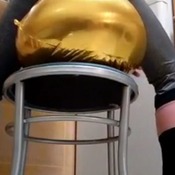 Golden balloons sit to pop