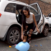 taking out and popping the balloons from the car
