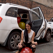 taking out and popping the balloons from the car